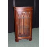 Mahogany standing corner cupboard, with dentil pediment above an astragal glazed door, on bracket