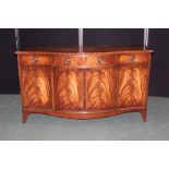 Reprodux mahogany sideboard, the serpentine front with three frieze drawers above four simulated