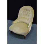 Edwardian nursing chair, upholstered in a gold coloured fabric, with button back nand serpentine
