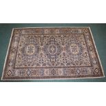 Middle Eastern carpet, the cream ground with blue lozenge pattern centre, surrounded by multiple
