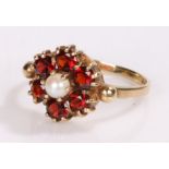 9 carat gold garnet and pearl ring, in the form of a flower head, ring size M