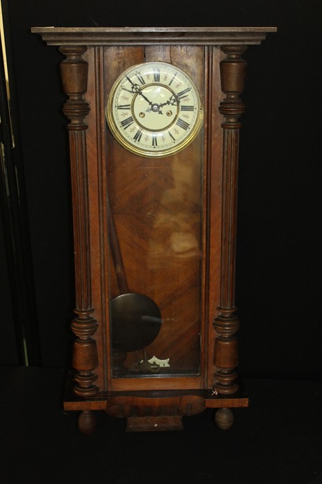 Vienna regulator wall clock, the ivory effect dial with Roman numerals, the glazed door flanked by