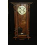 Vienna regulator wall clock, the ivory effect dial with Roman numerals, the glazed door flanked by