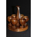 Hardwood egg cruet, retailed by Kottlers curio shop Cape Town, consisting of six egg cups on a stand