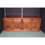 Old Charm oak sideboard, with four foliate carved drawers above four linen fold panelled cupboard