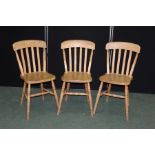 Three light wood dining chairs, with curved cresting rails above flattened splat back, solid