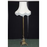 Edwardian brass standard lamp, of column form with reeded stem, on a stepped wreath decorated foot