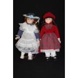 Two bisque dolls, on wooden plinth stands (2)