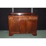 Oak sideboard, with upstand to the rear, three foliate carved frieze drawers above two panelled
