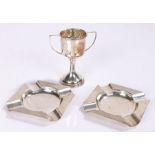 Two silver ashtrays, together with a silver trophy, 88 grams