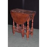 19th Century oak drop leaf table, with oval top and frieze drawer, on barley twist legs and