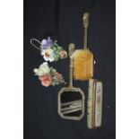 Two Capodimonte floral wall hangings, needlework decorated hand mirror, hairbrush and clothes