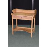 Victorian pine washstand, the three quarter splash back with shelf above a frieze drawer, on