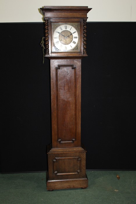 20th Century oak cased longcase clock, the hood with barley twist pilasters, the silvered chapter