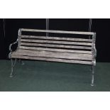 Garden bench, the scrolled cast iron ends with slatted back and seat, 153cm wide