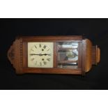 German oak cased wall clock, with scroll pediment above a glazed door, the dial with Roman numerals,