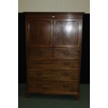 Victorian mahogany press cupboard, with bead carved pediment above two panelled cupboard doors,