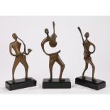 Series of three bronze figures depicting musicians, each mounted on a black plinth base, the largest