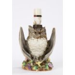 19th Century pottery oil lamp in the form of a bat with wings spread, raised on a floral bocage