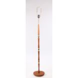 1970's teak and brass standard lamp, with shaped central column, on a circular plinth base 131.5cm