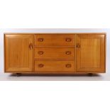 Ercol elm dresser with four drawers flanked by two cupboard doors, the central drawer with cutlery
