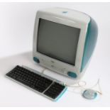 Apple iMac G3 desktop computer in Blueberry, with keyboard and mouse