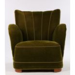 Mid 20th Century oak framed club chair, upholstered in a green velvet material, on curved oak feet