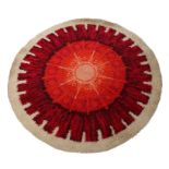 Mid 20th Century circular carpet, the cream ground with red and orange decoration, 198cm diameter