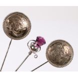 Three hat pins: a Charles Horner silver hat pin with an amethyst thistle top, stamped CH sterling, a