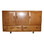 Ercol elm sideboard, with three cupboard doors above two drawers, the right hand cupboard with
