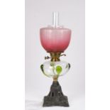 20th Century oil lamp, the frosted puce shade with etched foliate decoration, the clear reservoir