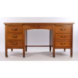 Early 20th Century oak desk, the rectangular faux leather inset top above six drawers to the