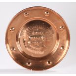 Copper Newlyn type charger, with embossed ship to the central field surrounded by a roundel