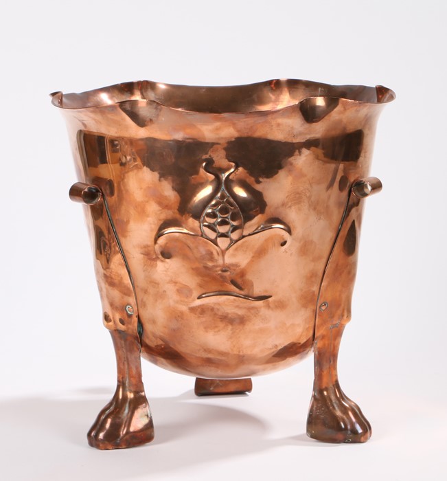 Art Nouveau copper jardinière, with wavy rim above an embossed floral decorated body, raised on