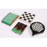 Four vintage powder compacts; a 'Datsun' compact in a black & white chequered pattern' an unusual