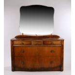 Mid 20th Century walnut veneered dressing table, the shaped mirror above three frieze drawers, the