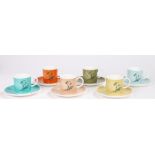 Susie Cooper set of six polychrome coffee cups and saucers with stylised floral decoration, housed