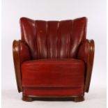 Mid 20th Century oak and red leather club chair, with curved chamfered show wood arms, on curved oak