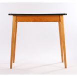 Mid 20th Century kitchen table, the cream melamine top with black edging, raised on light wood