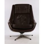 1970's brown leatherette upholstered swivel chair, with button back and seat, on a chrome base