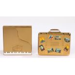 A 'Volupte' 'Pianette' compact in the shape of a gold piano, and a 'Kigu' 'Bon Voyage' suitcase