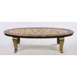 Onyx and brass coffee table by Muller of Mexico, the oval top raised on brass carbiole legs, 149.5cm