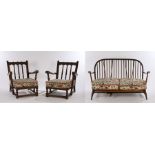 Ercol dark stained two seat settee with turned spindle back and down swept arms with turned