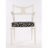 White painted elbow chair, with pierced splat back, shaped arms, overstuffed black and white spot