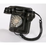 Mid 20th century wall mounted telephone, with rotating dial and shaped hand piece