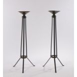 Pair of iron and brass candle stands, the dished detachable sconces with spikes to their centres, on