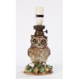 19th Century pottery oil lamp in the form of an owl raised on a floral bocage decorated base,