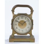 French brass mantel clock, with pierced handle above a compass, the silvered dial with Arabic