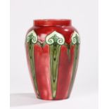 Minton Ltd Art Nouveau vase, with tube lined scroll decoration on a red ground, stamped to base