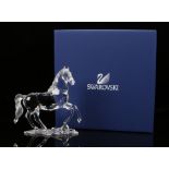 Swarovski standing horse figure with front leg raised, 14.5cm high, housed in a fitted case with